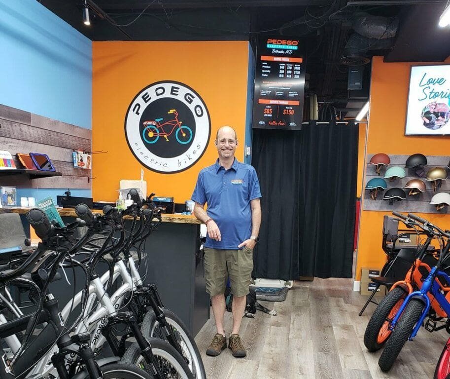 Owner of Pedego Bethesda, David Bondareff, standing inside his new Pedego store.