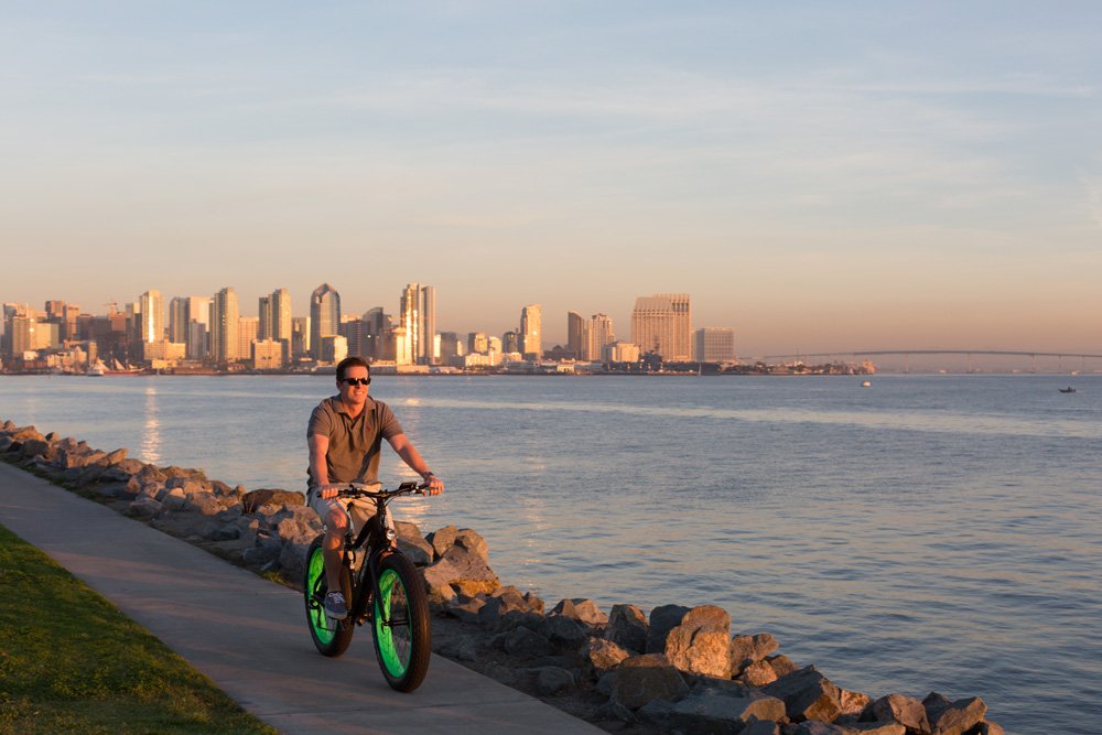 Man riding Pedego Trail Tracker along the water.