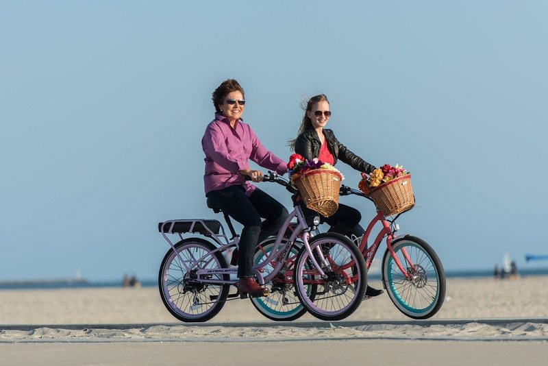 Mother and daugther riding Pedego electric bikes together