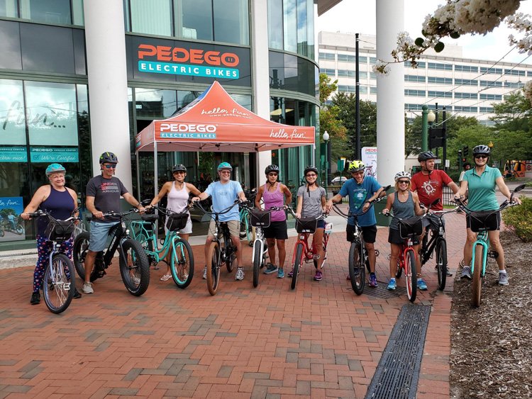 Pedego riders outside of the Norfolk storefront.