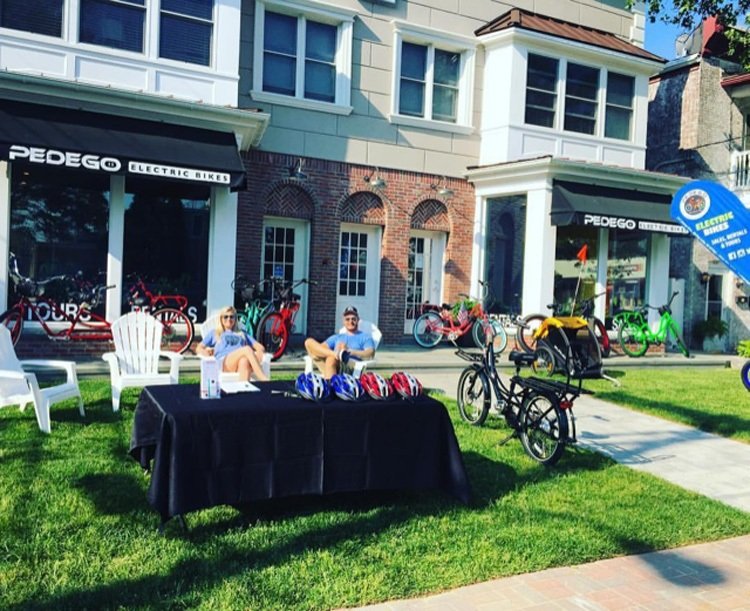 Owners of Pedego Spring Lake outside their storefront.